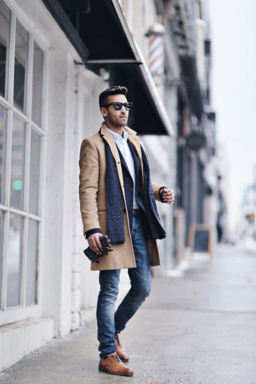 Camel coat, blue scarf, a crisp white shirt, jeans, and brown shoes
