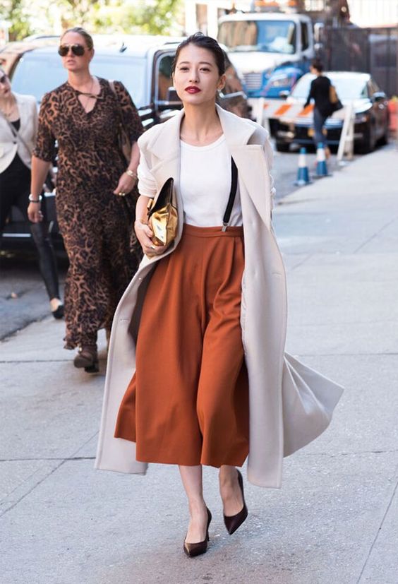 Picture Of a white tee, burnt orange culottes, brown shoes, black