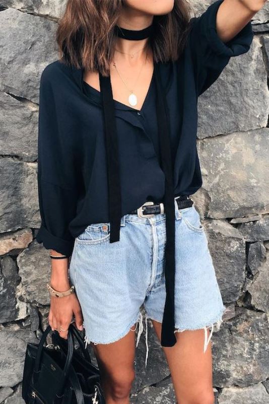 Picture Of Old Fashioned Raw Hem Denim Shorts With A Black Blouse