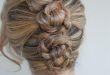 Make three ponytails, braid, then twist into three buns and pin